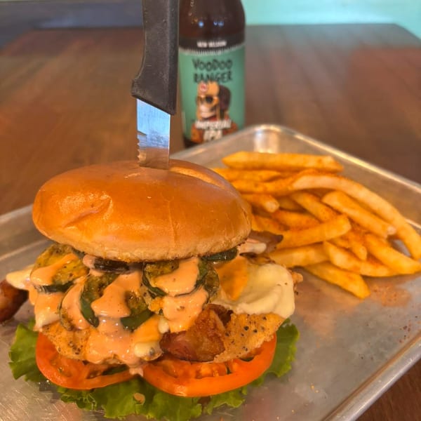 A TJ's Burgers, Wings, and Pizza burger with fries and a Voodoo Ranger beer.