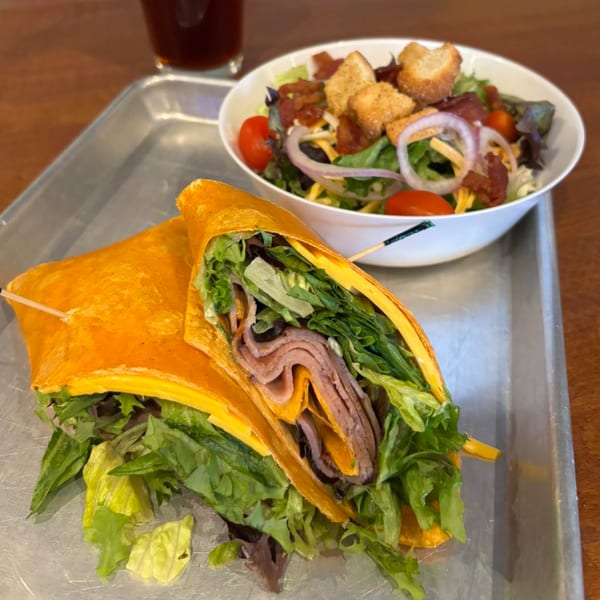 TJ's Burgers, Wings, and Pizza's roast beef wrap and side salad with bacon and croutons.